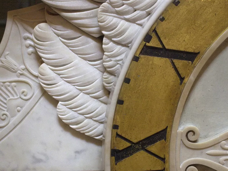 Marble sculpture and portion of clock face.