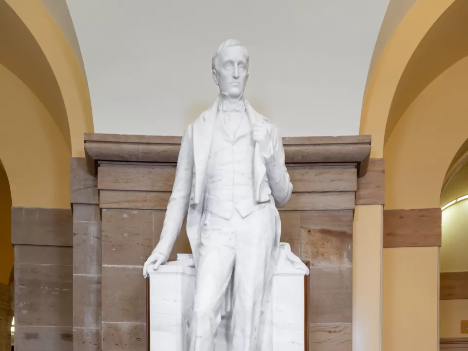 Marble statue of a person standing.