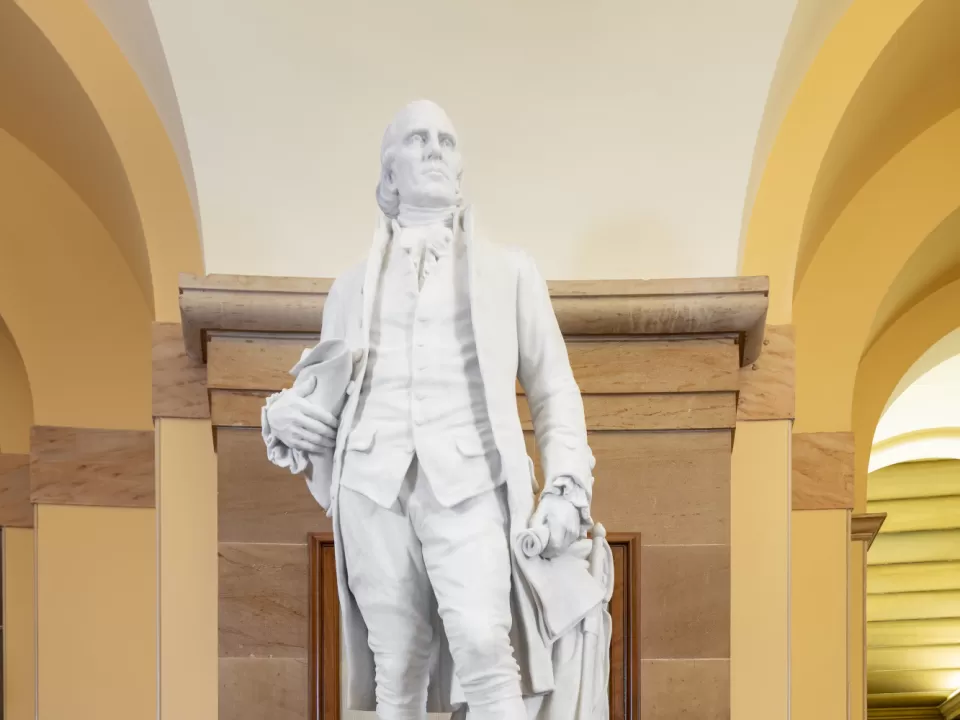 Marble statue of a person standing.