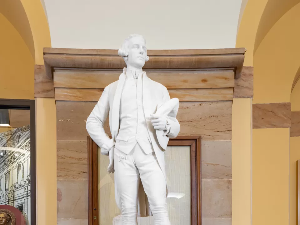 Marble statue of a person standing.