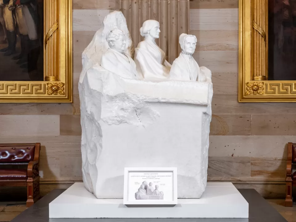 Marble sculpture of three partial figures.