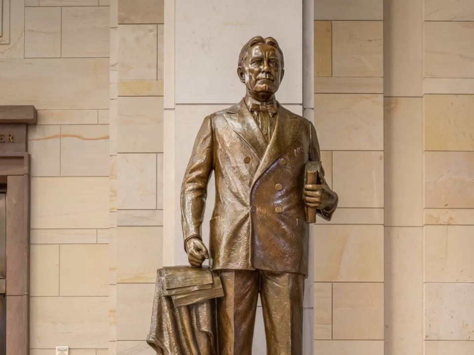 Bronze statue of a person standing.