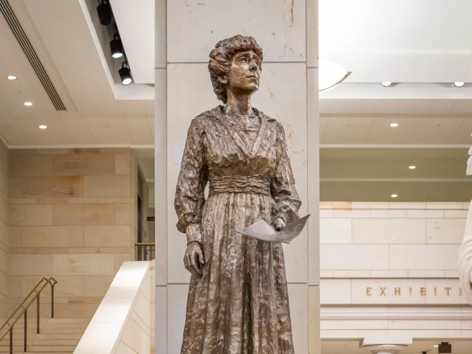 Bronze statue of a person standing.