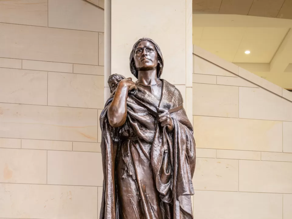 Bronze statue of a person standing.