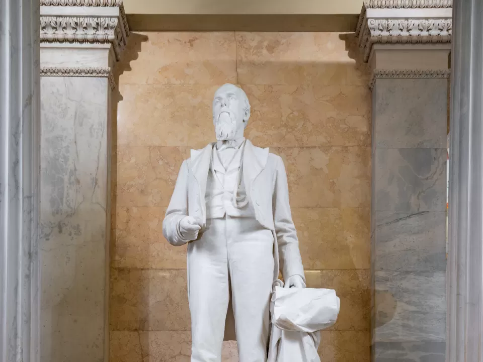 Marble statue of a person standing.