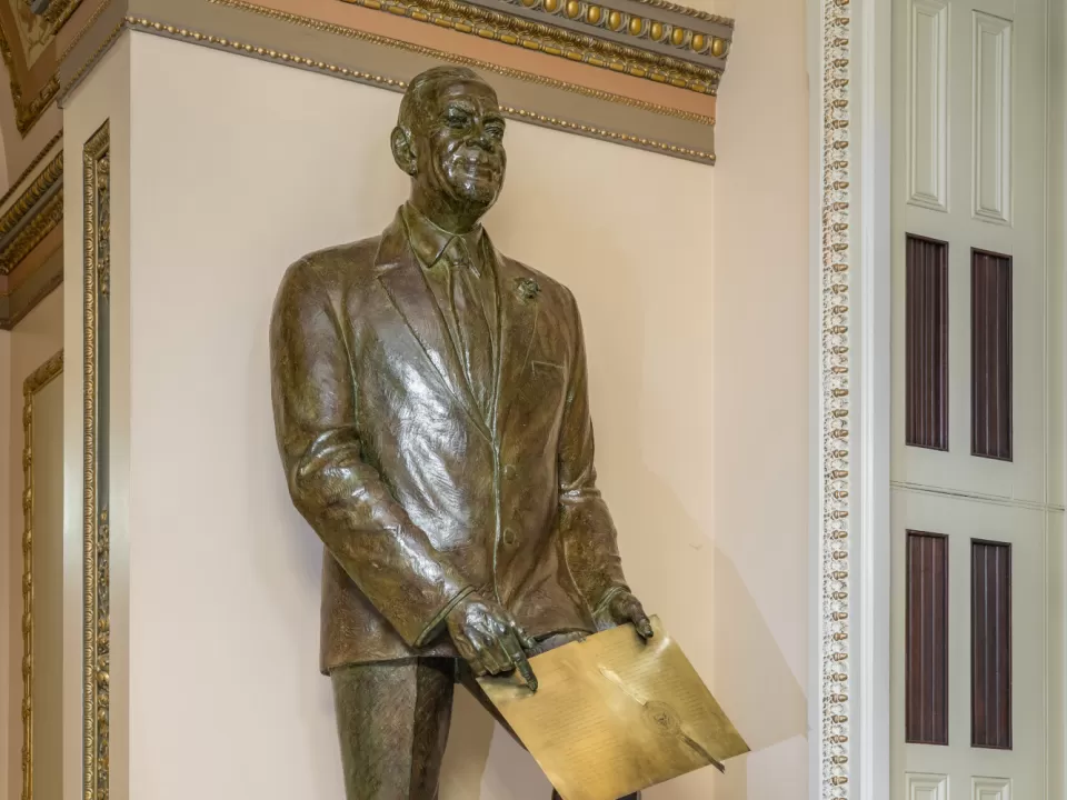 Bronze statue of a person standing.