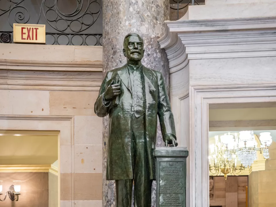 Bronze statue of a person standing.