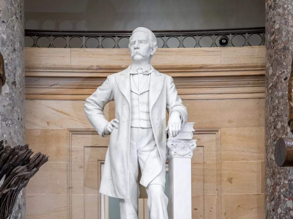 Marble statue of a person standing.