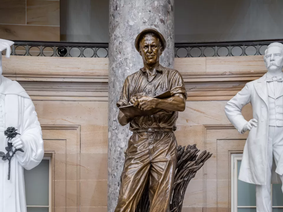 Bronze statue of a person standing.