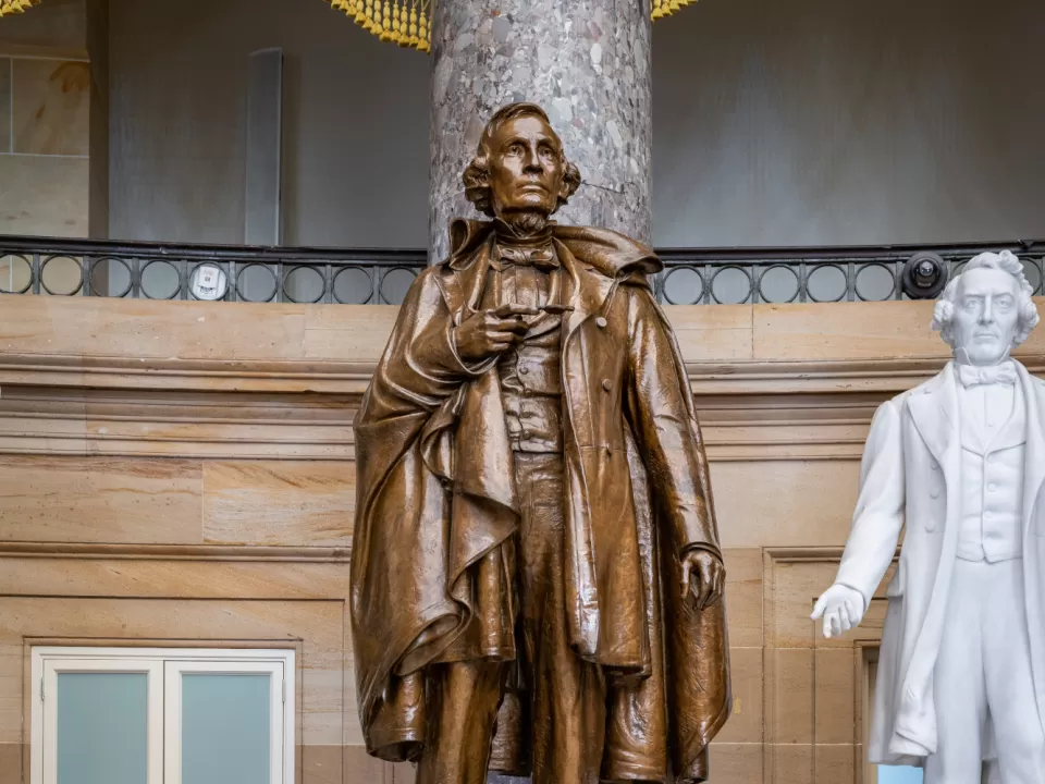 Bronze statue of a person standing.