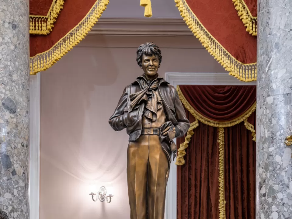 Bronze statue of a person standing.