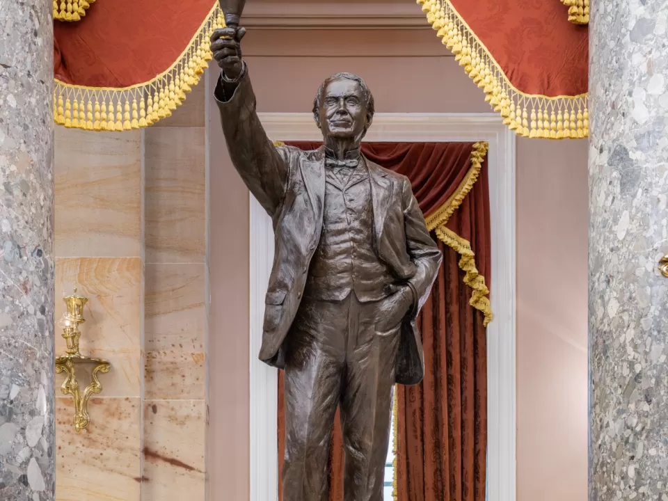 Bronze statue of a person standing.