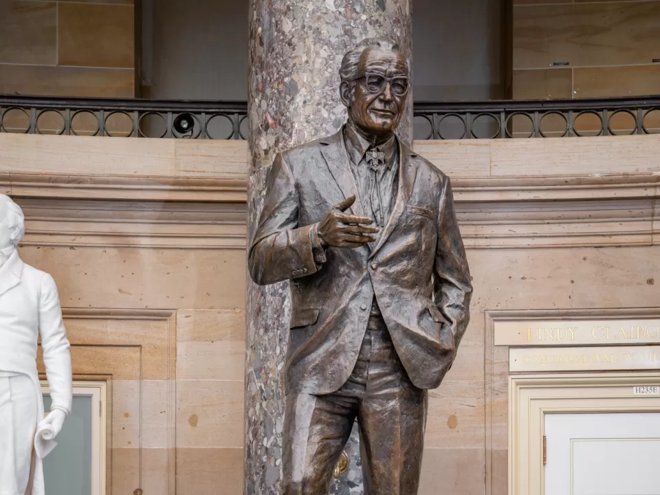 Bronze statue of a person standing.