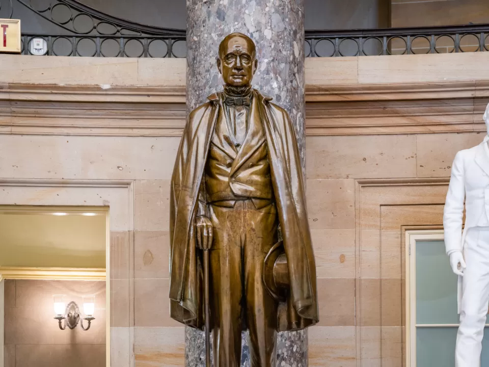 Bronze statue of a person standing.