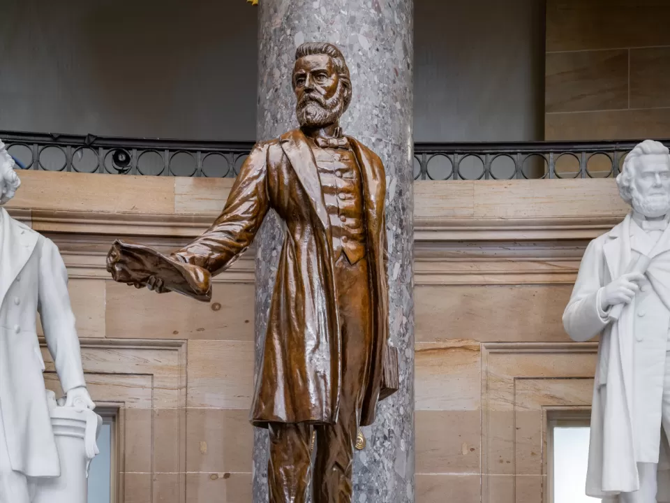 Bronze statue of a person standing.