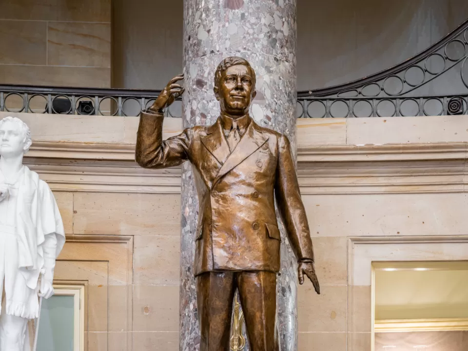 Bronze statue of a person standing.