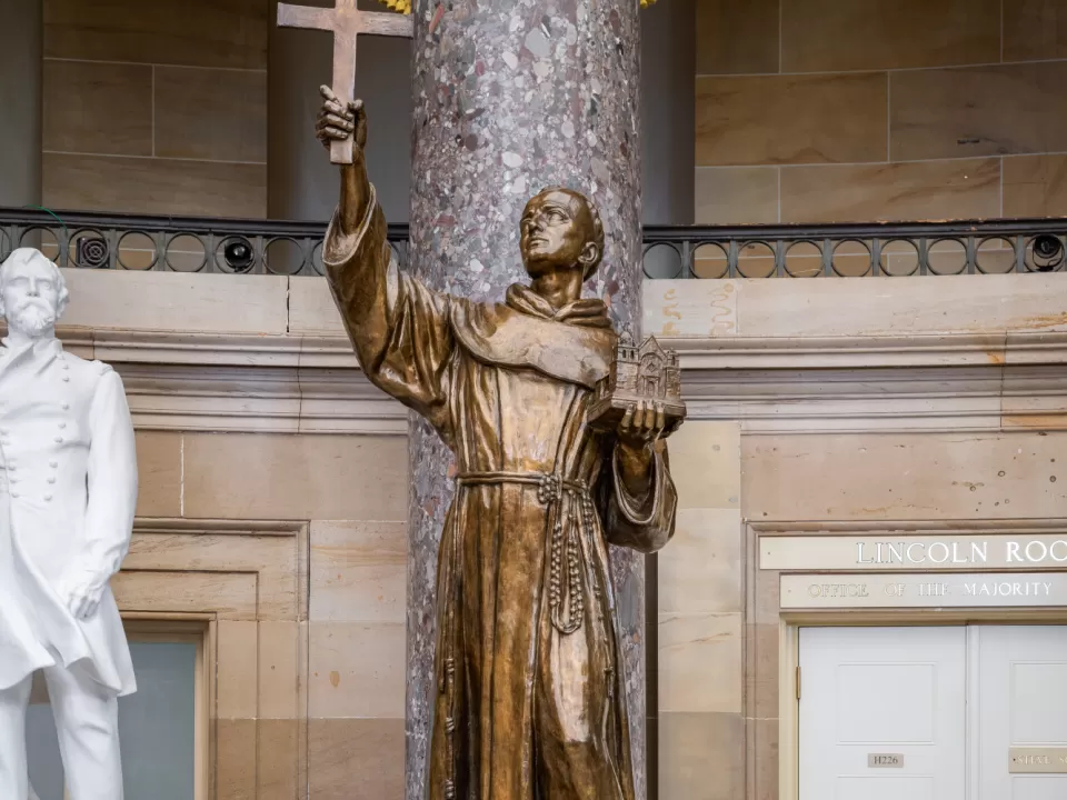 Bronze statue of a person standing.