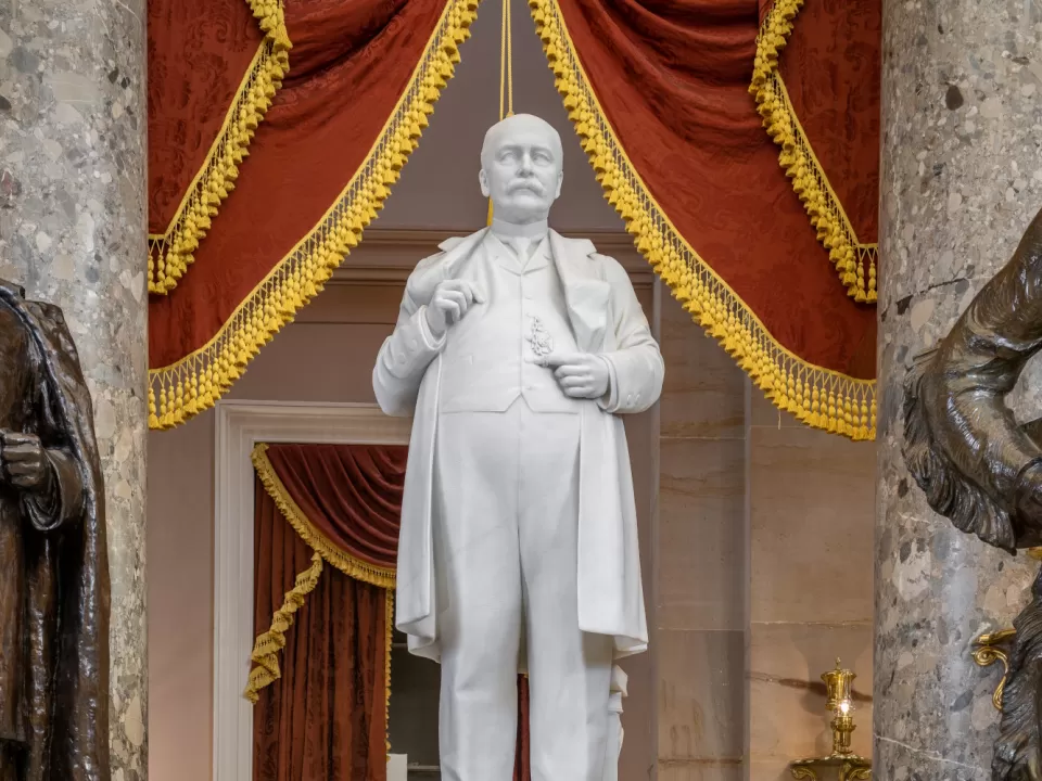 Marble statue of a person standing.