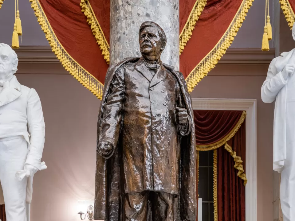 Bronze statue of a person standing.