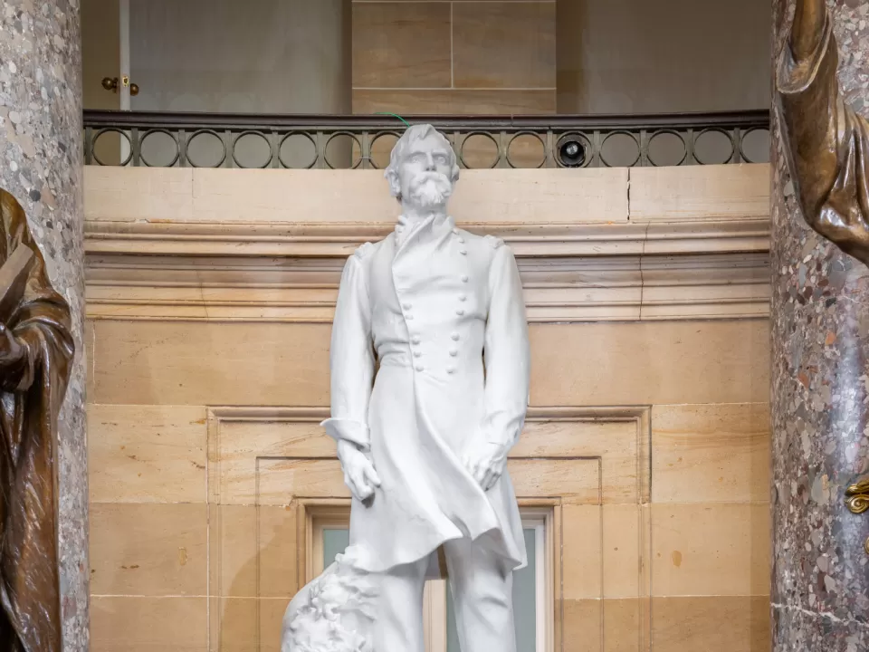 Marble statue of a person standing.