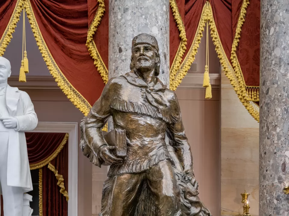 Bronze statue of a person standing.