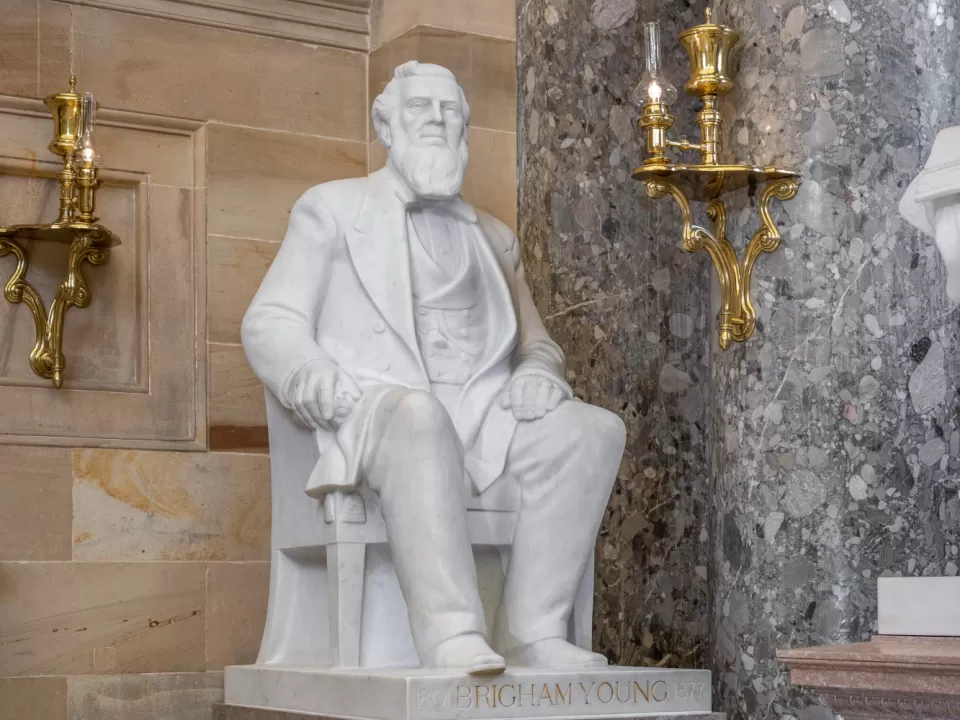 Marble statue of a person sitting.