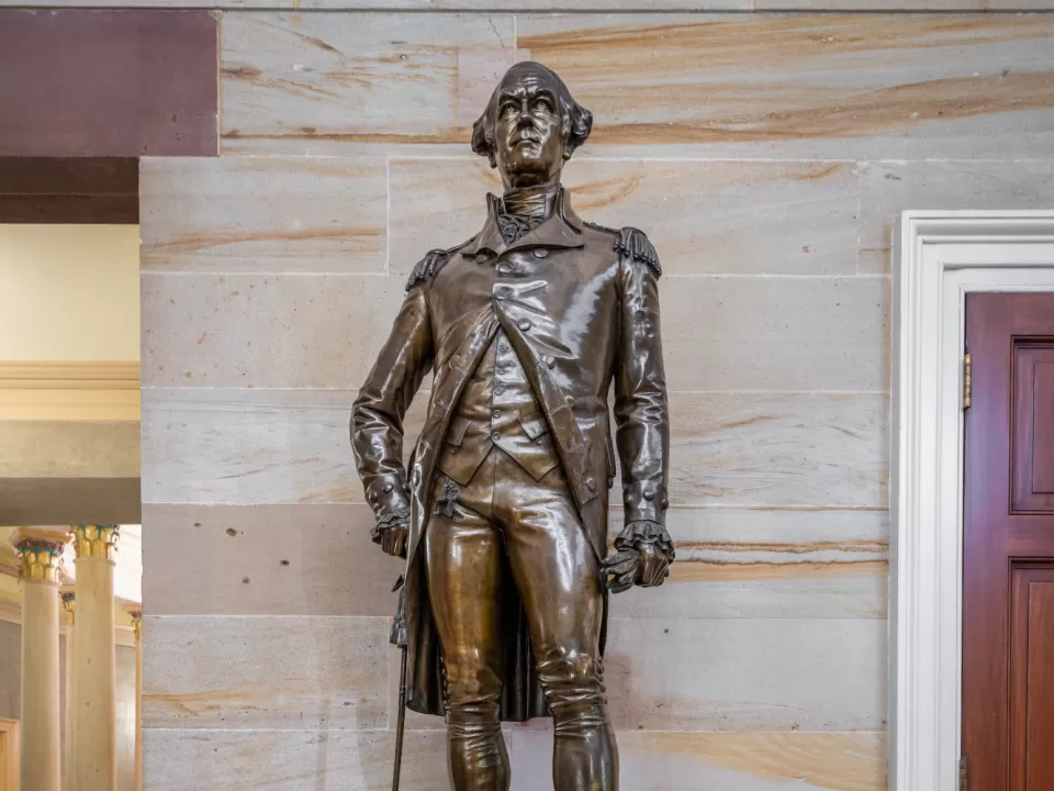 Bronze statue of a person standing.