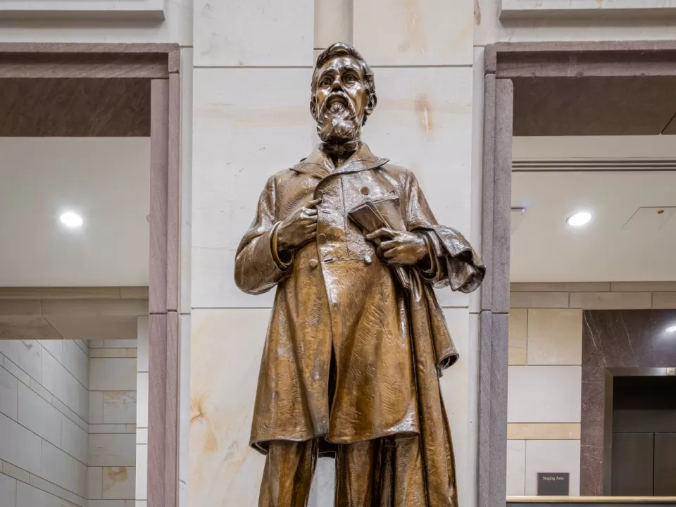 Bronze statue of a person standing.