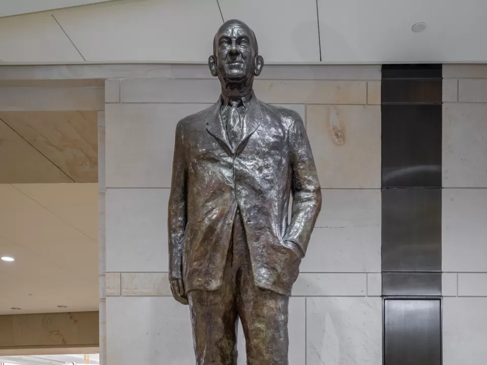 Bronze statue of a person standing.