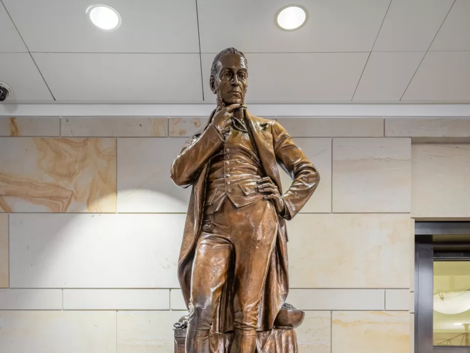 Bronze statue of a person standing.