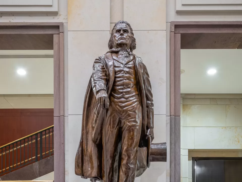 Bronze statue of a person standing.