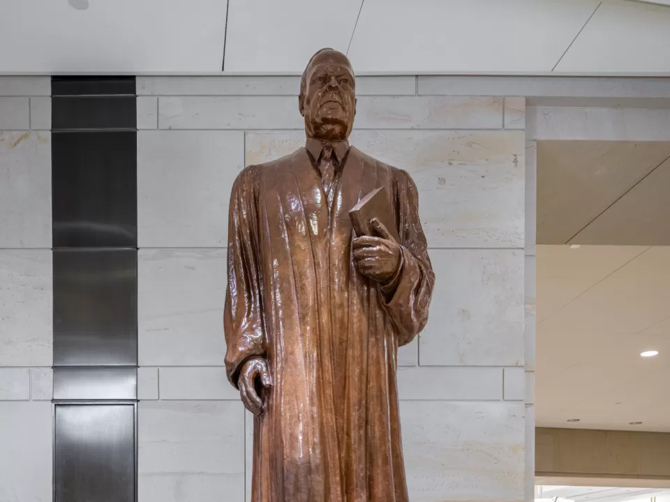 Bronze statue of a person standing.