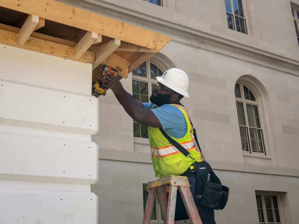 Person standing on ladder.