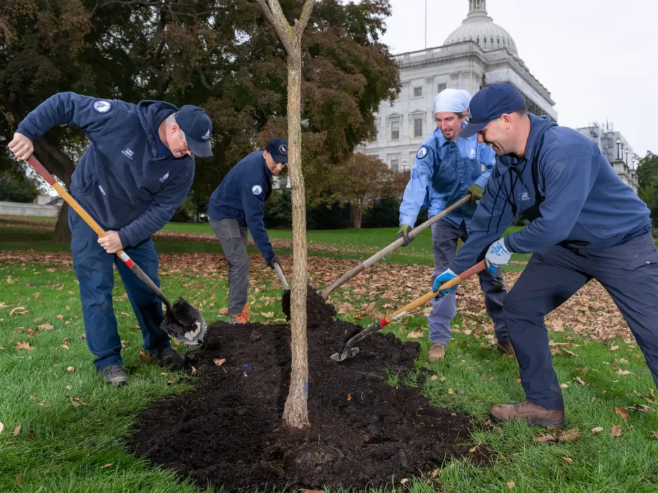 People holding shovels.