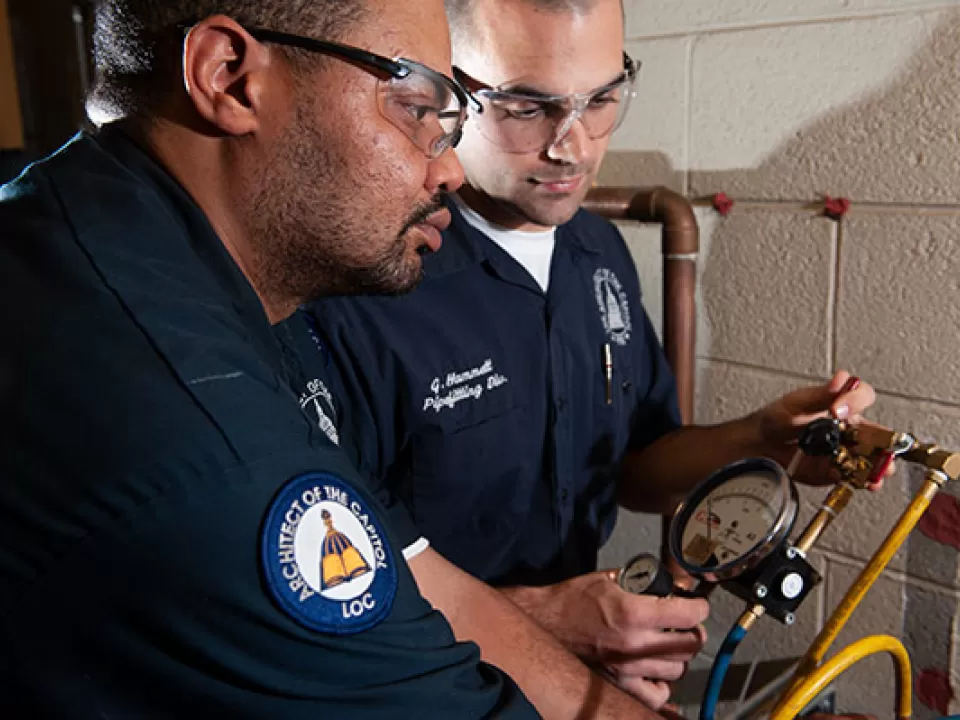 AOC Library Buildings and Grounds plumbing crew members.