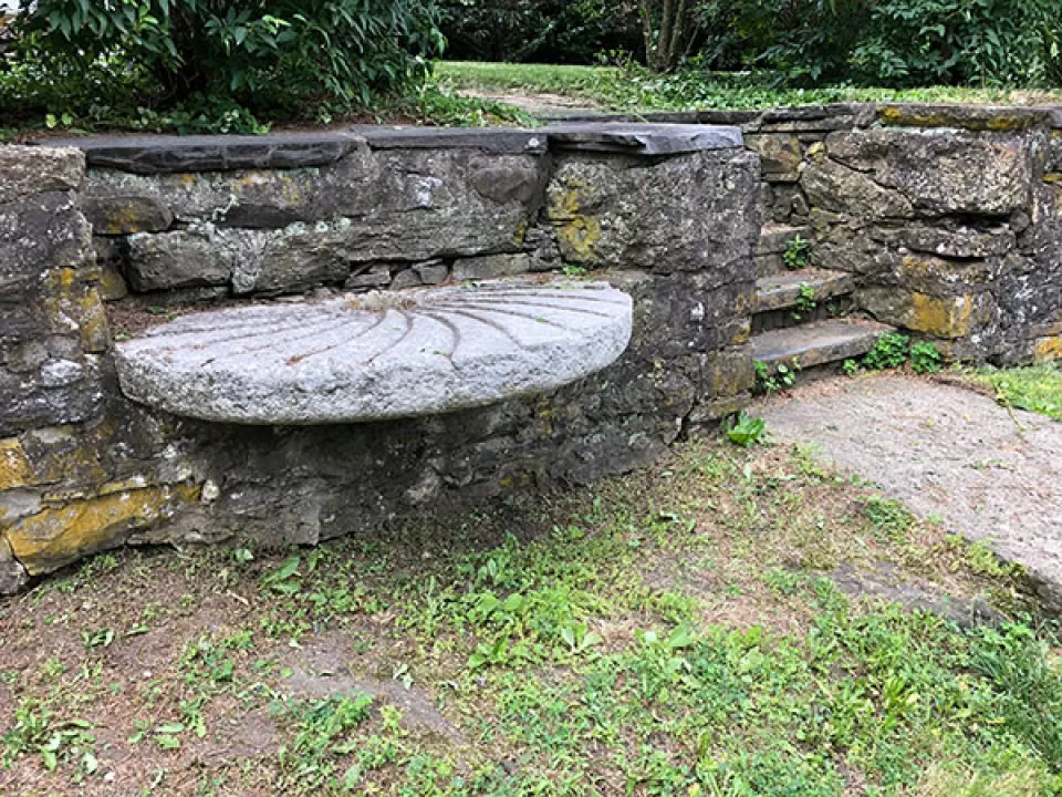 A bench made of millstone in the wall became a marker for the De Witt house location.