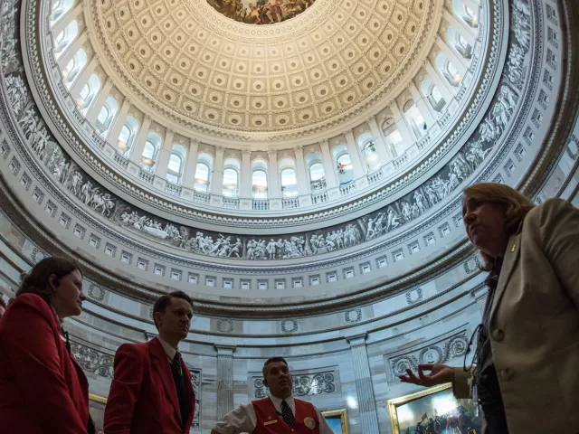 Capitol Visitor Center guides admire the freshly restored space.