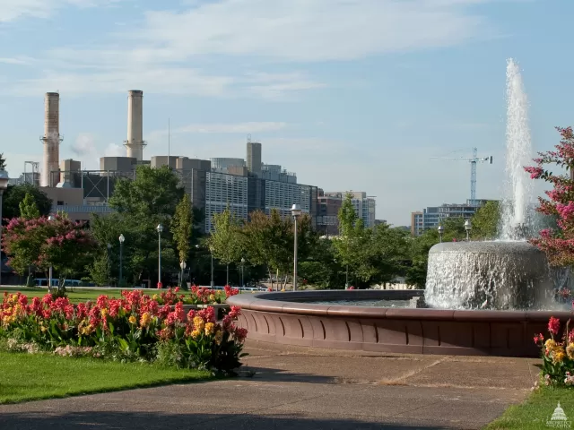 Fountain and landscaping with a view of the Capitol Power Plant from a distance. 