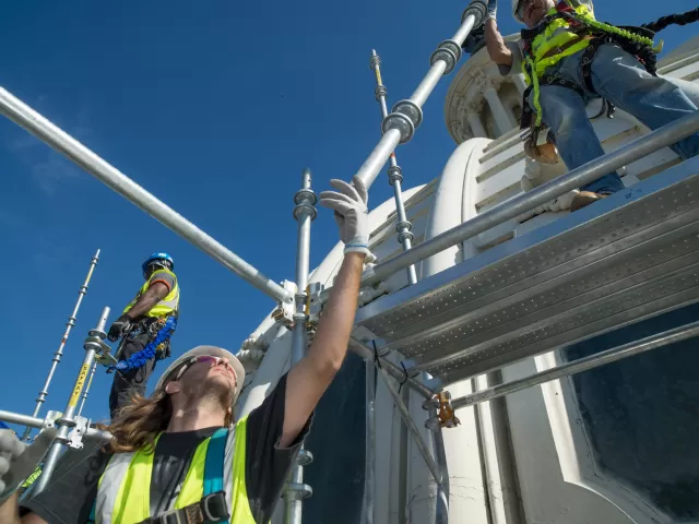 Placement of elements of scaffold that will reach, and eventually cover, the entire Capitol Dome enabling restoration work on Dome.