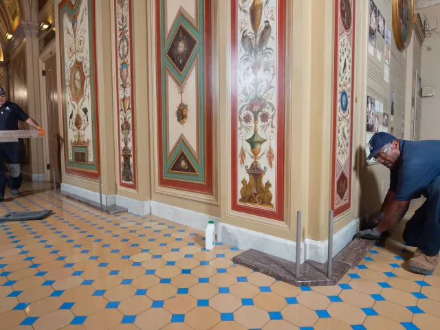 Workers restoring Brumidi Corridors