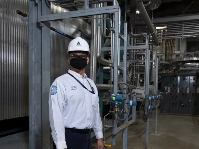 Sequester Team Leader Ladislaus “Dave” Jagoda in front of the cogeneration system at the Capitol Power Plant