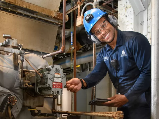 Gary Bowser inspects a boiler fan to ensure that it is properly lubricated and that safety systems are working correctly.