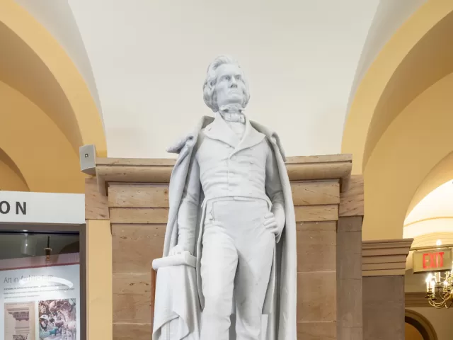 Marble statue of a person standing.