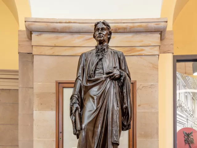 Bronze statue of a person standing.