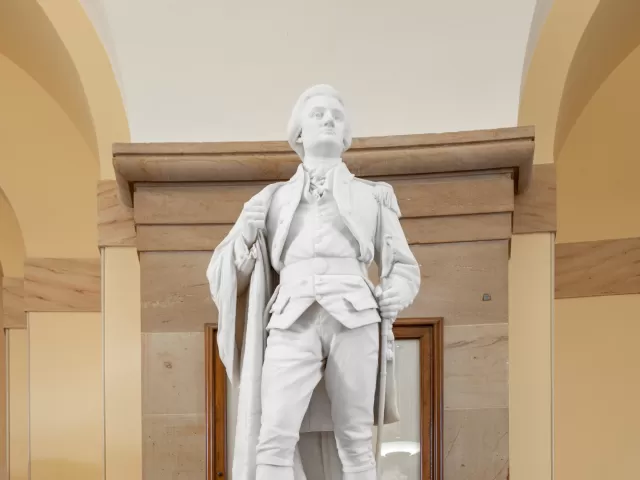 Marble statue of a person standing.