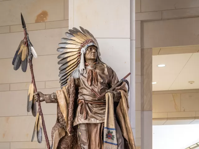 Bronze statue of a person standing.