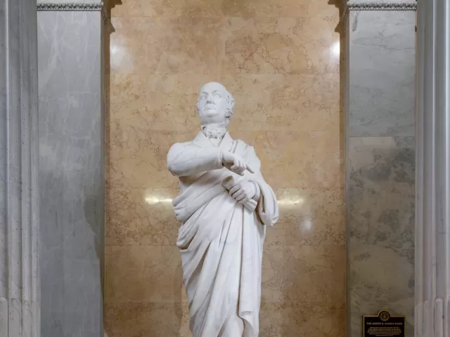 Marble statue of a person standing.