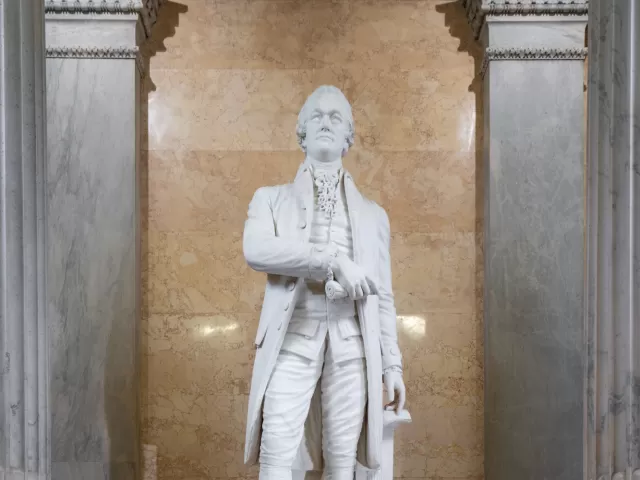 Marble statue of a person standing.