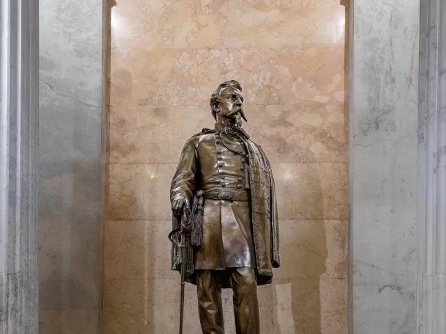 Bronze statue of a person standing.