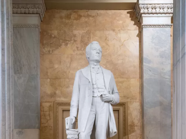 Marble statue of a person standing.